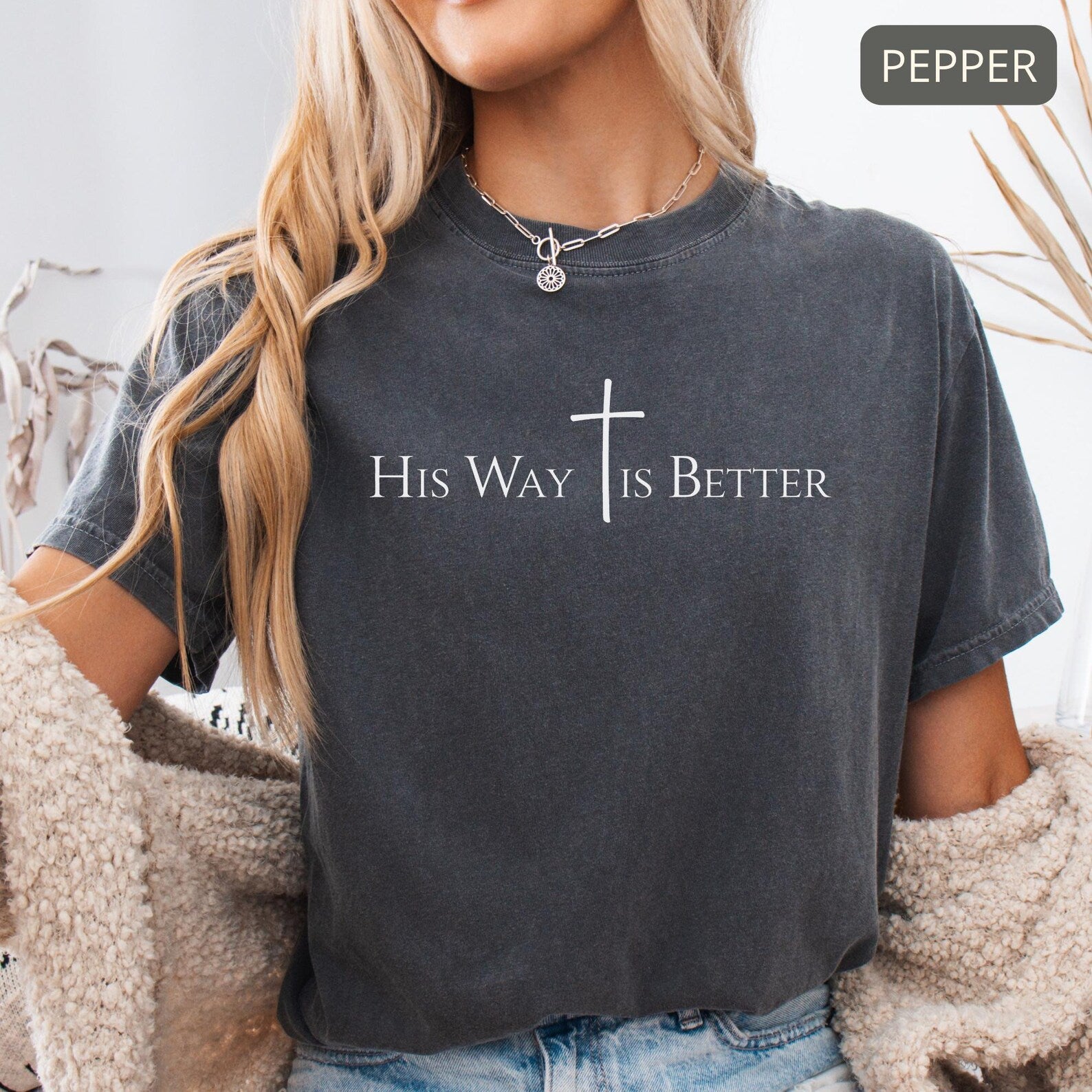 Ivory Christian tee styled casually with denim jeans and jewelry